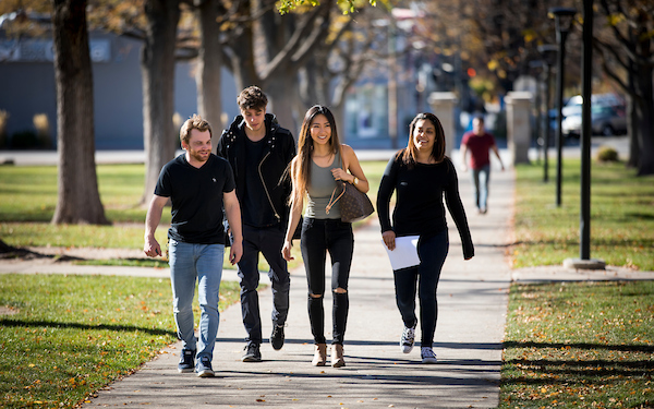 four students walking on campus